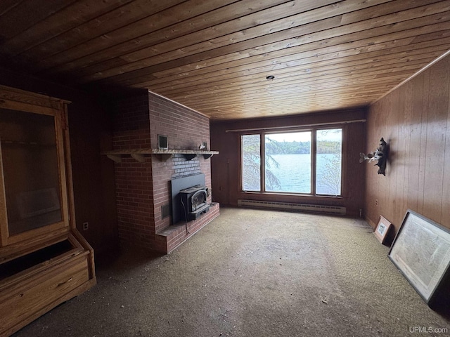 514/324 S Brook St, Michigamme, MI 49861 - unfurnished living room featuring a baseboard radiator, a wood stove, wooden ceiling, wooden walls, and carpet floors
