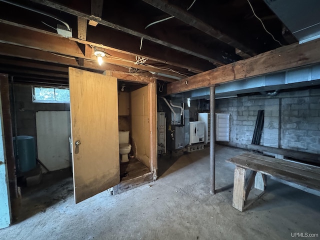 514/324 S Brook St, Michigamme, MI 49861 - below grade area with heating unit, washer / dryer, and water heater