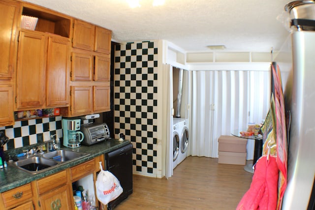 11330 Packard Ave, Warren, MI 48089 - kitchen featuring washing machine and clothes dryer, dishwasher, a sink, dark countertops, and a textured ceiling