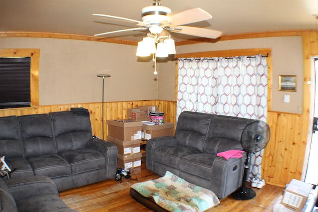 11330 Packard Ave, Warren, MI 48089 - living room featuring wood walls, ceiling fan, wood finished floors, and wainscoting