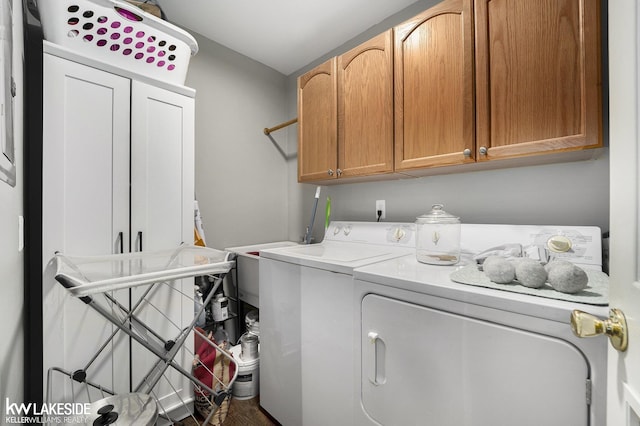 56214 Troon Dr, Shelby Twp, MI 48316 - washroom with washing machine and clothes dryer, cabinet space, and wood finished floors