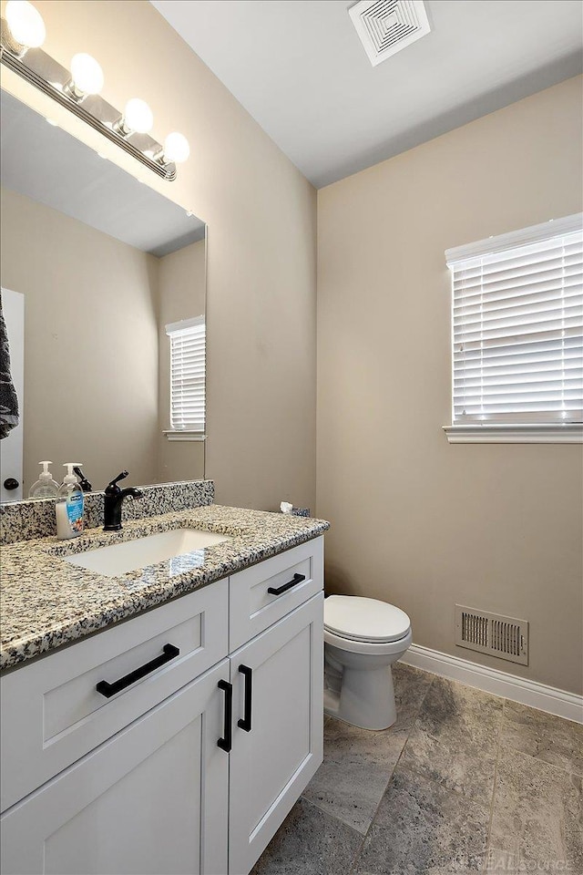 29696 Kevin Rd, New Baltimore, MI 48051 - half bathroom with vanity, toilet, baseboards, and stone finish flooring