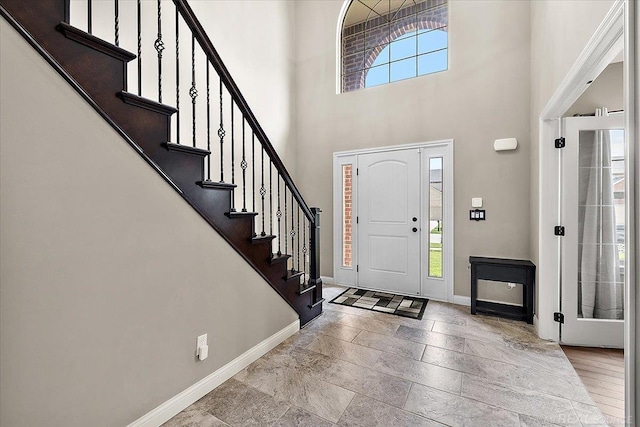 29696 Kevin Rd, New Baltimore, MI 48051 - foyer entrance with baseboards, stairs, a towering ceiling, and stone tile floors