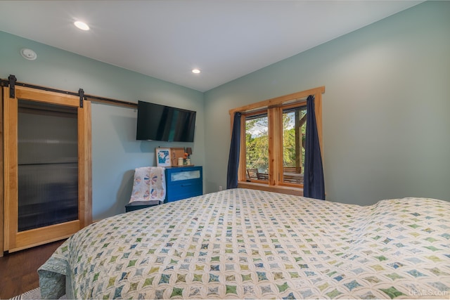 509 Red Rd, Michigamme, MI 49861 - bedroom featuring wood finished floors, a barn door, and recessed lighting