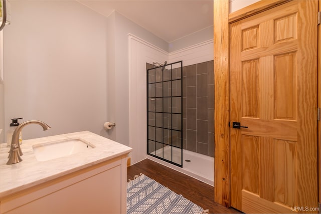 509 Red Rd, Michigamme, MI 49861 - full bath with a tile shower, vanity, and wood finished floors