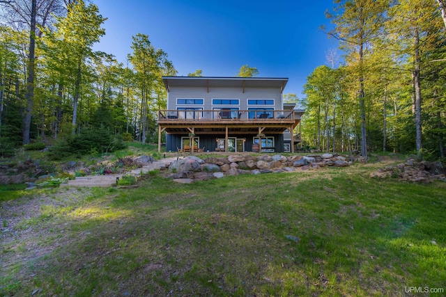509 Red Rd, Michigamme, MI 49861 - back of house featuring a wooden deck, a yard, and board and batten siding