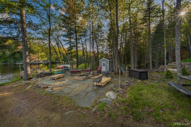 509 Red Rd, Michigamme, MI 49861 - view of yard featuring an outdoor fire pit, a patio, and a water view