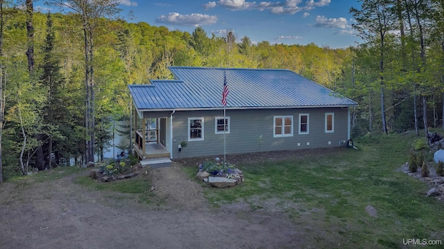 509 Red Rd, Michigamme, MI 49861 - rear view of property with a forest view and metal roof