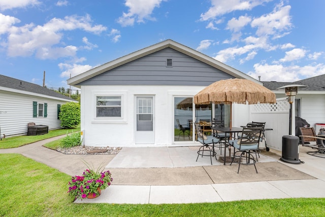 5616 W Houghton Lake Dr, Houghton Lake, MI 48629 - back of house with a patio