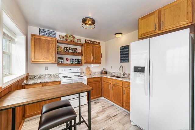 5616 W Houghton Lake Dr, Houghton Lake, MI 48629 - kitchen with white appliances, a sink, open shelves, and brown cabinets