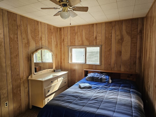 5316 Birchwood Ave, Gladwin, MI 48624 - bedroom with wood walls, carpet floors, and a ceiling fan
