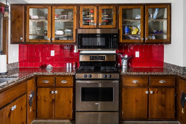 37207 27 Mile Rd, Roads, Lenox, MI 48048 - kitchen with gas range, backsplash, glass insert cabinets, and brown cabinets