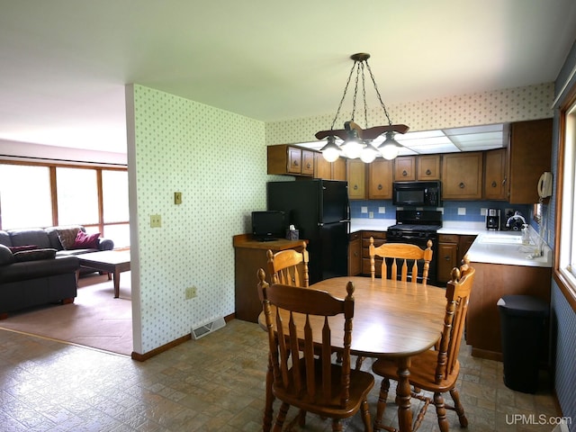 26514 Hendrickson Rd, Calumet, MI 49913 - dining room featuring wallpapered walls, baseboards, and a chandelier