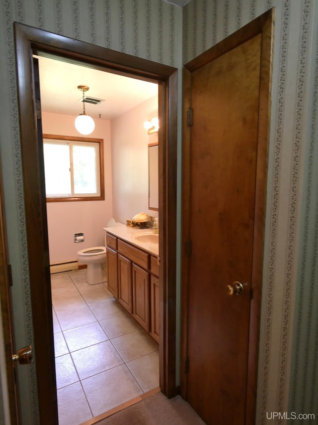26514 Hendrickson Rd, Calumet, MI 49913 - bathroom featuring vanity, a baseboard radiator, toilet, and tile patterned floors