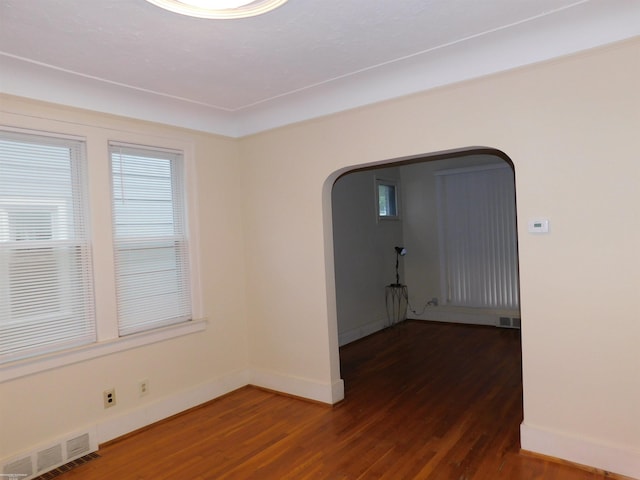 1364 Beaconsfield Ave, Grosse Pointe Park, MI 48230 - spare room with arched walkways, wood finished floors, and baseboards