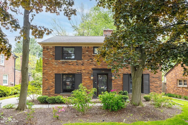 766 Lakeland St, Grosse Pointe, MI 48230 - view of front facade with brick siding and a chimney