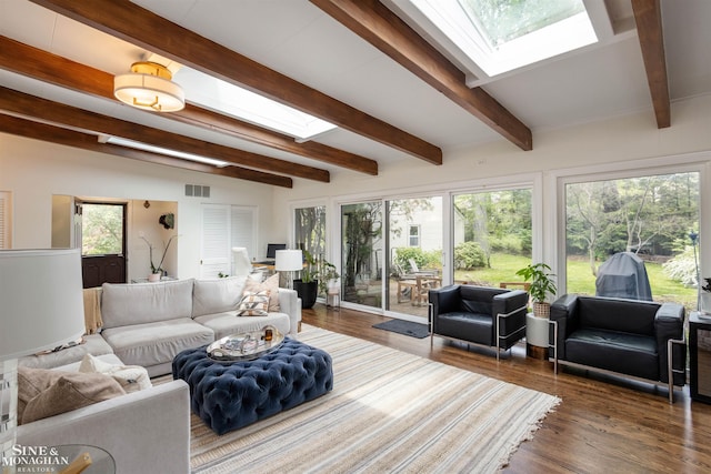 766 Lakeland St, Grosse Pointe, MI 48230 - living area featuring a skylight, beam ceiling, wood finished floors, and plenty of natural light