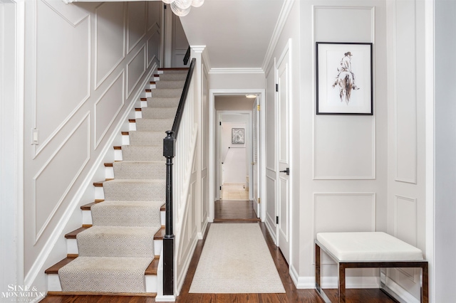766 Lakeland St, Grosse Pointe, MI 48230 - staircase with wood finished floors, crown molding, and a decorative wall