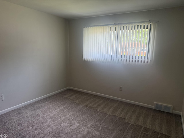 26167 Fairfield Ave, Warren, MI 48089 - spare room with dark colored carpet and baseboards