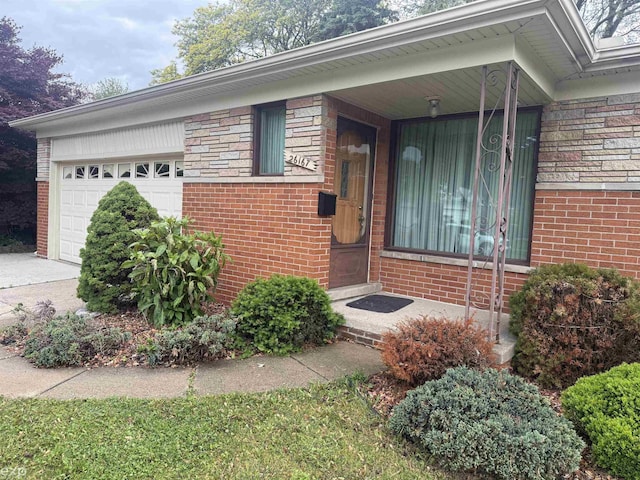 26167 Fairfield Ave, Warren, MI 48089 - property entrance with brick siding and an attached garage