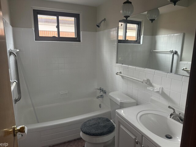26167 Fairfield Ave, Warren, MI 48089 - full bath with tile walls, healthy amount of natural light, tub / shower combination, toilet, and vanity
