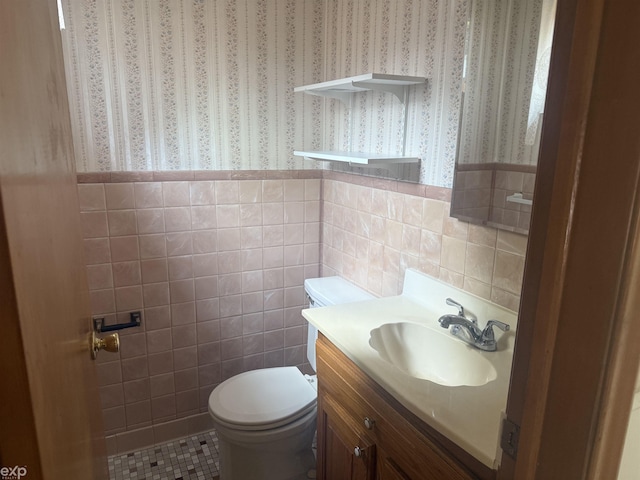 26167 Fairfield Ave, Warren, MI 48089 - half bath featuring wallpapered walls, toilet, vanity, wainscoting, and tile walls