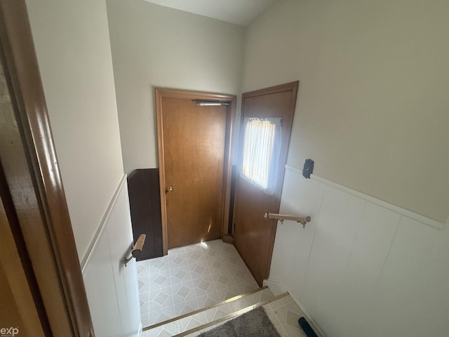 26167 Fairfield Ave, Warren, MI 48089 - staircase featuring a wainscoted wall, a decorative wall, and tile patterned flooring