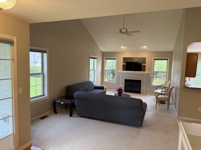 119 Pondview Ct, Brighton, MI 48116 - living area with healthy amount of natural light, a tiled fireplace, carpet, lofted ceiling, and baseboards
