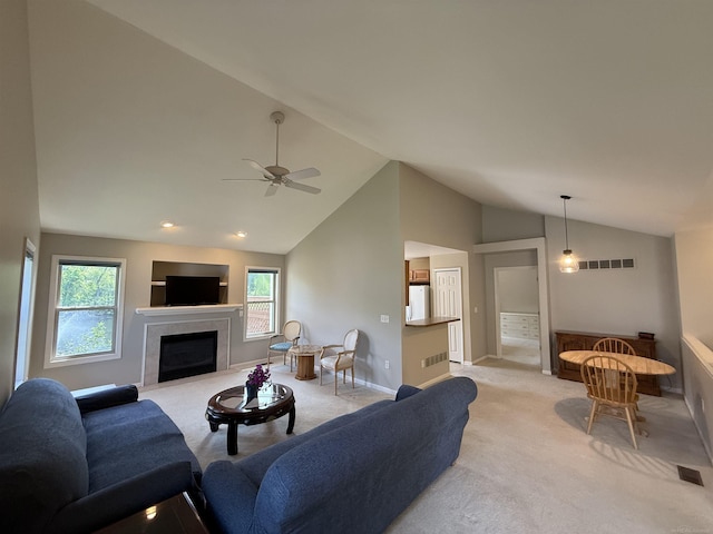 119 Pondview Ct, Brighton, MI 48116 - living area with light carpet, lofted ceiling, a ceiling fan, healthy amount of natural light, and baseboards