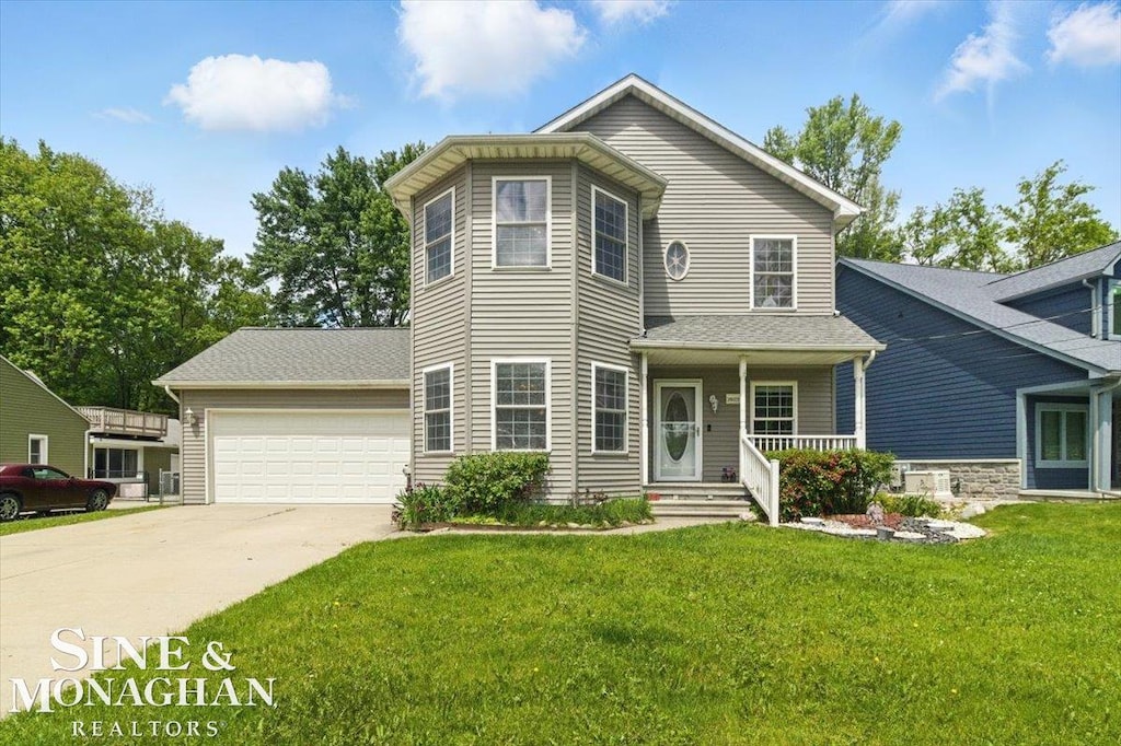 26123 Clear St, Harrison Twp, MI 48045 - view of front of property with driveway, a front lawn, a garage, and covered porch