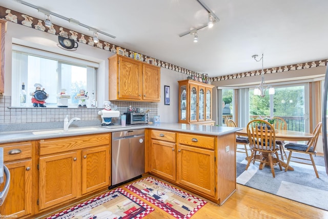 518 Lexington Dr, Rochester Hills, MI 48307 - kitchen featuring dishwasher, track lighting, a peninsula, light countertops, and backsplash