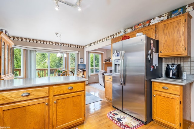 518 Lexington Dr, Rochester Hills, MI 48307 - kitchen featuring stainless steel refrigerator with ice dispenser, light wood finished floors, light countertops, and hanging light fixtures