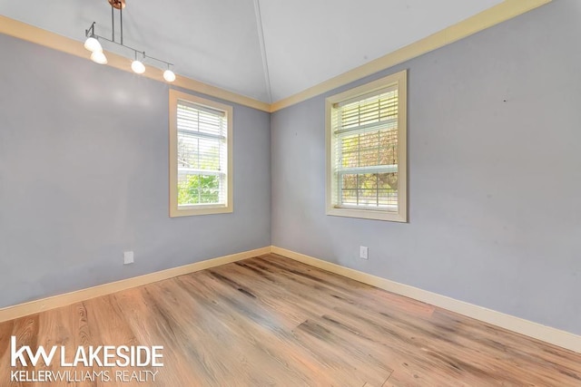 7184 Baker Rd, Worth Twp, MI 48450 - empty room with baseboards, track lighting, and wood finished floors
