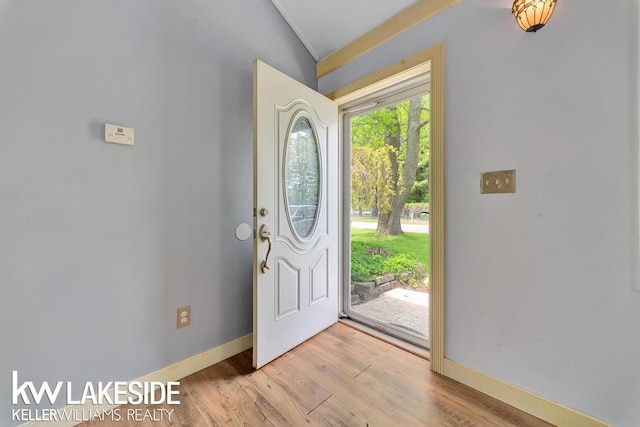 7184 Baker Rd, Worth Twp, MI 48450 - foyer entrance with lofted ceiling, light wood-style flooring, and baseboards