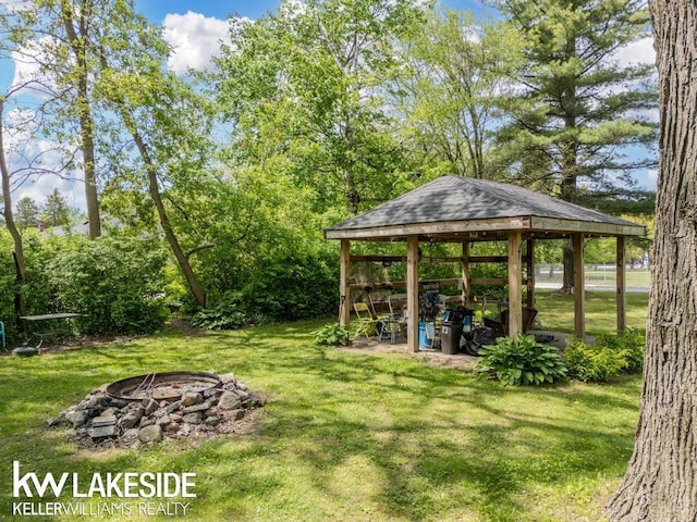 7184 Baker Rd, Worth Twp, MI 48450 - view of green lawn featuring an outdoor fire pit and a gazebo