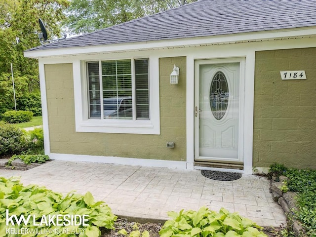 7184 Baker Rd, Worth Twp, MI 48450 - entrance to property featuring a shingled roof and concrete block siding