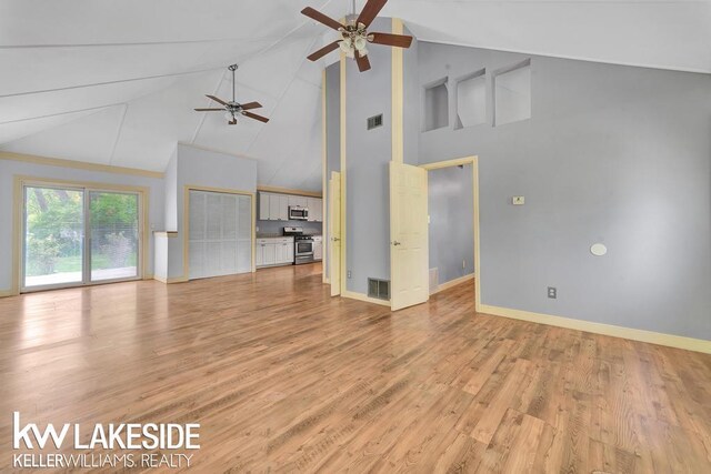 7184 Baker Rd, Worth Twp, MI 48450 - unfurnished living room featuring a ceiling fan, high vaulted ceiling, light wood-type flooring, baseboards, and beamed ceiling