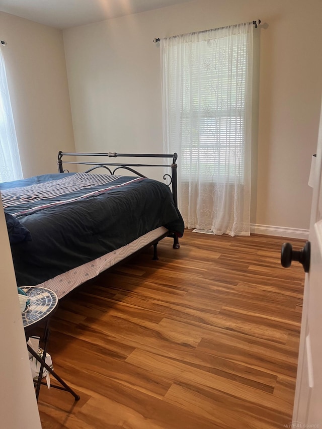 727 Townsend Dr, Algonac, MI 48001 - bedroom featuring wood finished floors and baseboards