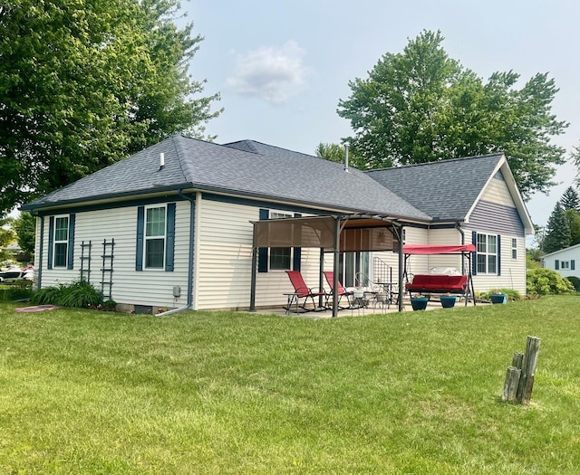 727 Townsend Dr, Algonac, MI 48001 - back of house featuring a patio, roof with shingles, and a lawn