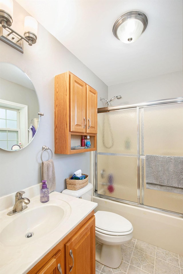 8735 Blackberry Ln, Port Austin, MI 48467 - full bathroom with vanity, enclosed tub / shower combo, toilet, and tile patterned floors
