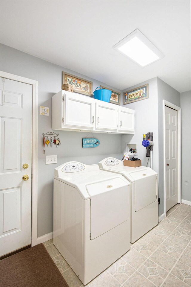 8735 Blackberry Ln, Port Austin, MI 48467 - laundry area featuring cabinet space, washing machine and dryer, and baseboards