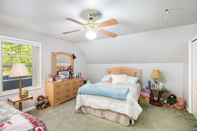 8735 Blackberry Ln, Port Austin, MI 48467 - carpeted bedroom with lofted ceiling, a ceiling fan, and baseboards