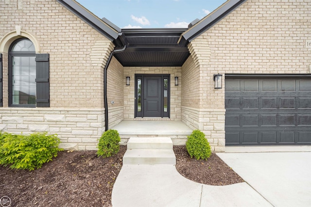 16612 Via Villagio Dr, Macomb, MI 48042 - view of exterior entry with a garage, brick siding, and concrete driveway