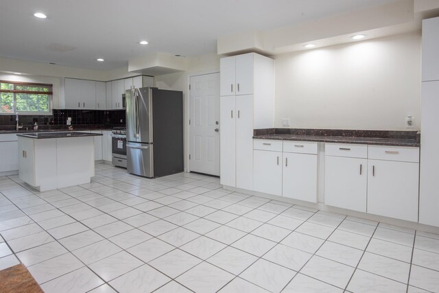 5311 Cambourne Pl, West Bloomfield, MI 48322 - kitchen featuring appliances with stainless steel finishes, decorative backsplash, a sink, white cabinetry, and recessed lighting