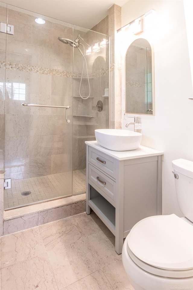 5311 Cambourne Pl, West Bloomfield, MI 48322 - bathroom with vanity, toilet, a stall shower, and marble look tile flooring