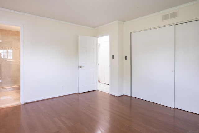 5311 Cambourne Pl, West Bloomfield, MI 48322 - unfurnished bedroom featuring wood finished floors, crown molding, a closet, baseboards, and connected bathroom