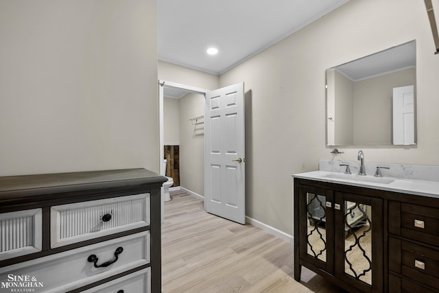 26898 Alderman Ct, Harrison Twp, MI 48045 - bathroom featuring ornamental molding, vanity, wood finished floors, baseboards, and recessed lighting