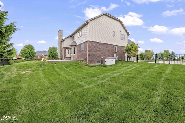 26898 Alderman Ct, Harrison Twp, MI 48045 - back of house featuring brick siding and a chimney