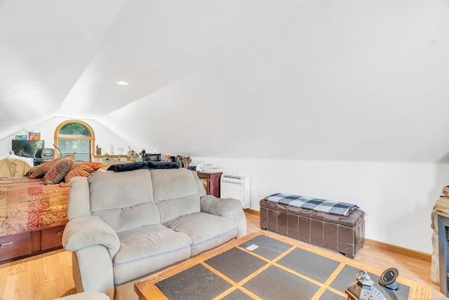 7696 Varty Ct, Lexington, MI 48450 - living room featuring lofted ceiling, wood finished floors, and baseboards