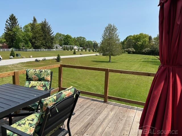 7696 Varty Ct, Lexington, MI 48450 - wooden deck with a yard, view of wooded area, and a view of countryside